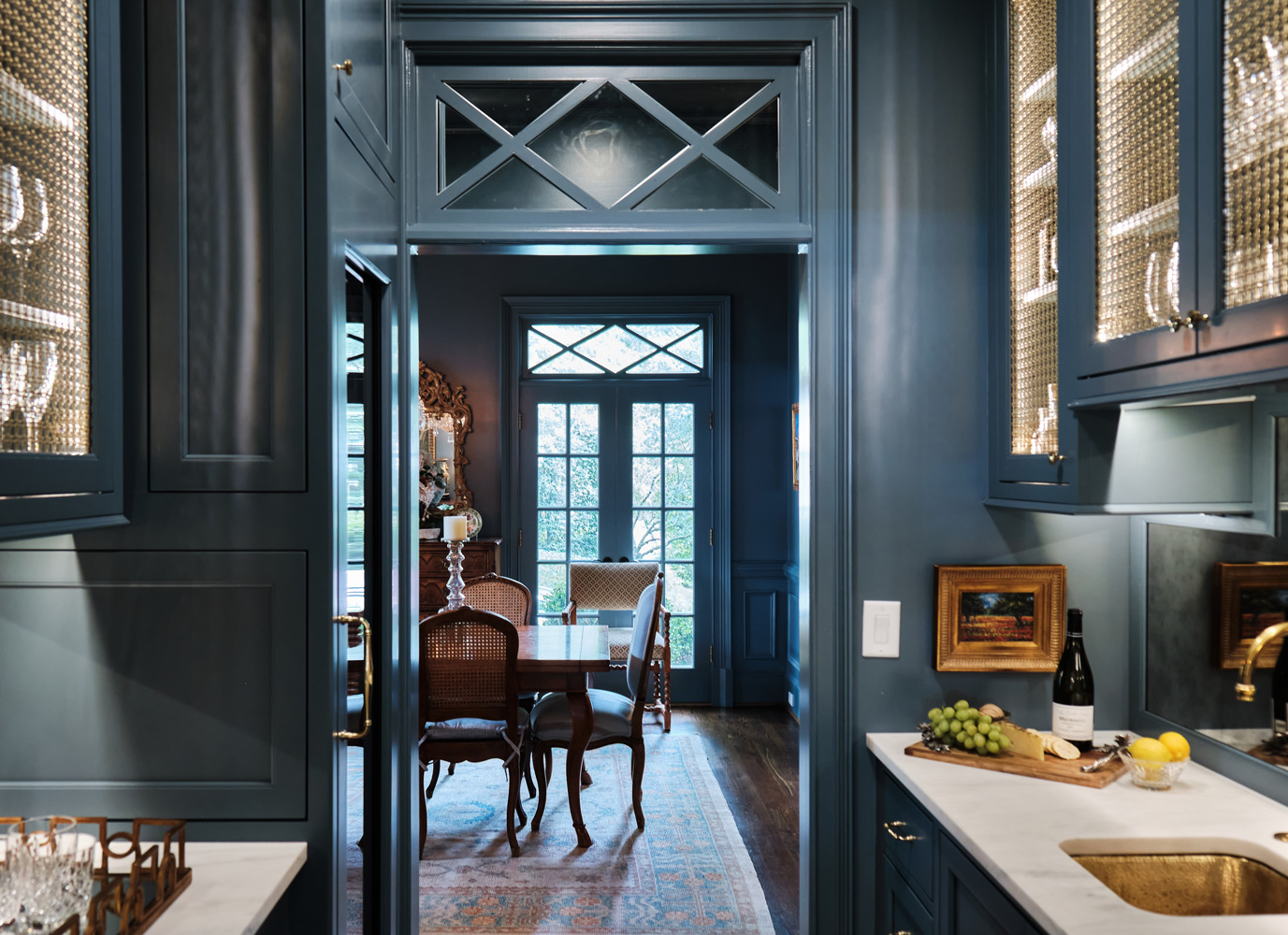 the blue bar area leading into the dining room that carries the color from the kitchen to the dining area