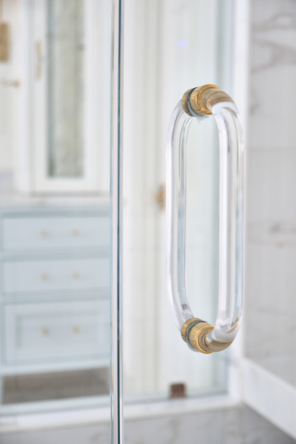 a glass handle with brass trim for the shower door