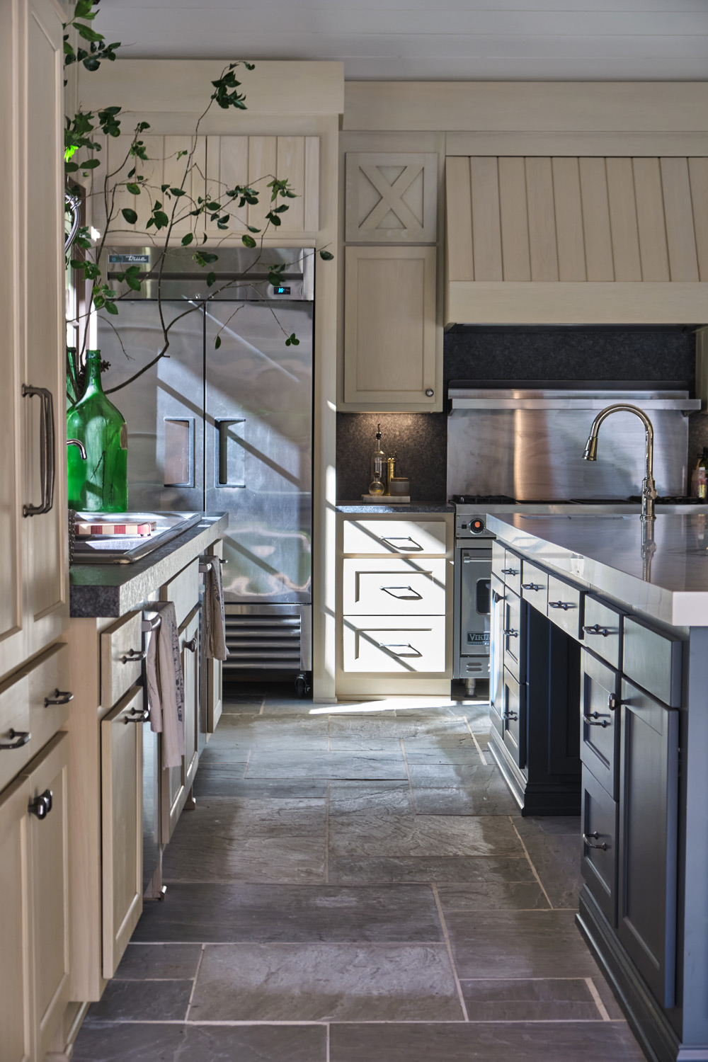a long view of the pool house's stone floor in the kitchen