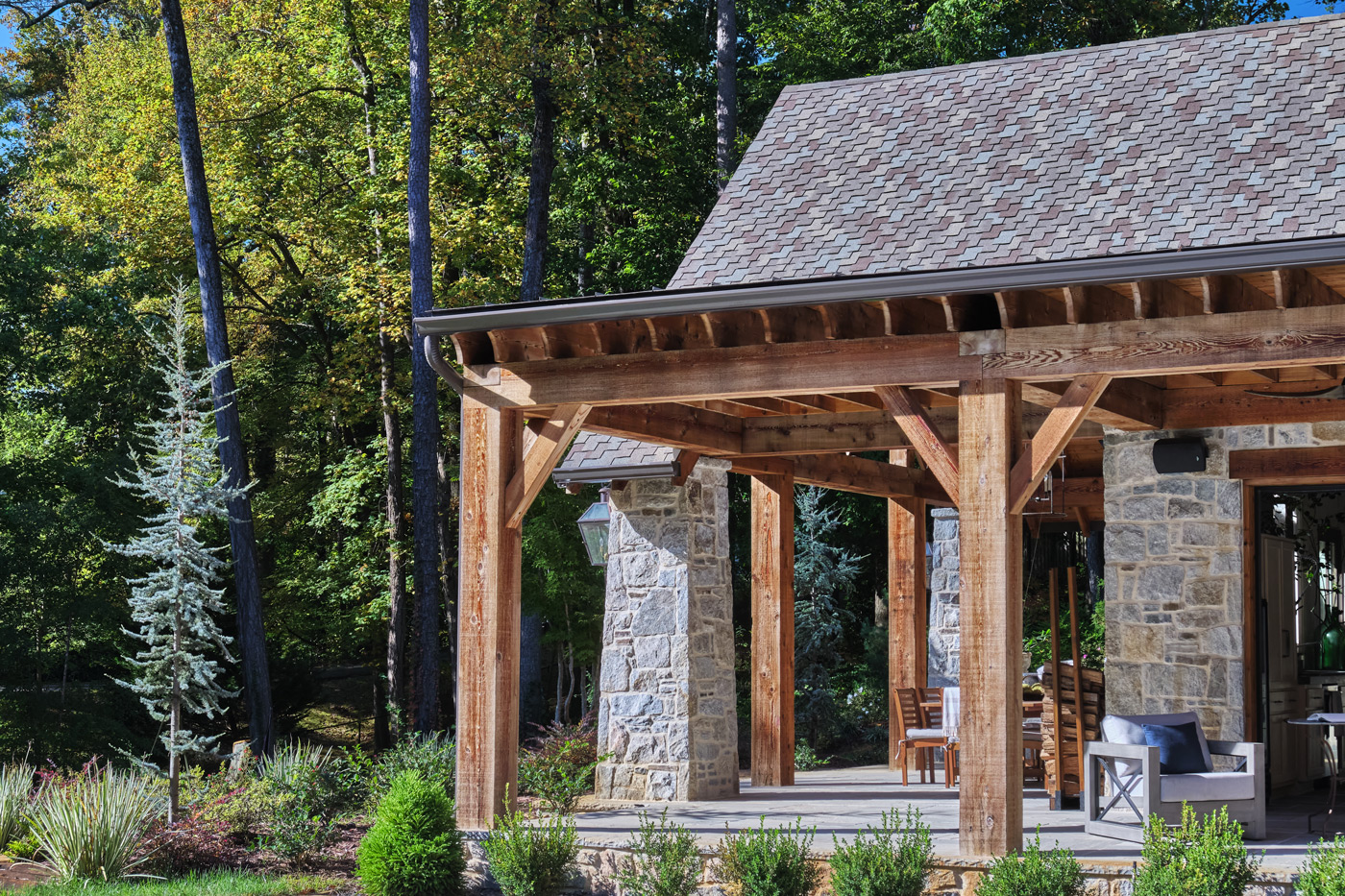 stone and woodwork of the corner of the pool house as seen from the pool